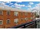 Balcony overlooking a red brick building under a cloudy blue sky at 400 4Th S Ave # 301, St Petersburg, FL 33701