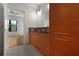 Elegant bathroom with double vanity and wood cabinets, view to bedroom at 400 4Th S Ave # 301, St Petersburg, FL 33701