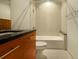 Bathroom with modern vanity with dark countertops and tiled shower/tub combination at 400 4Th S Ave # 301, St Petersburg, FL 33701