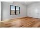 Bedroom with hardwood floors, window with blinds, and double closets at 400 4Th S Ave # 301, St Petersburg, FL 33701