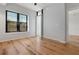 Bright bedroom with hardwood floors, large window with blinds, and access to balcony at 400 4Th S Ave # 301, St Petersburg, FL 33701