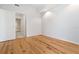 Cozy bedroom features hardwood floors and a door leading to an ensuite bathroom at 400 4Th S Ave # 301, St Petersburg, FL 33701