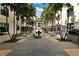Exterior courtyard featuring mature palm trees, manicured greenery, black river rock beds, and a decorative water feature at 400 4Th S Ave # 301, St Petersburg, FL 33701