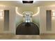 A well-lit hallway featuring accent lighting and artwork leads to a view of the courtyard at 400 4Th S Ave # 301, St Petersburg, FL 33701