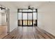 Bright living room featuring hardwood floors, large windows, and ceiling fan at 400 4Th S Ave # 301, St Petersburg, FL 33701
