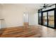 Bright and airy living room featuring hardwood floors, a ceiling fan, and a sliding door to a balcony at 400 4Th S Ave # 301, St Petersburg, FL 33701