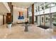 Elegant lobby with travertine floors, large windows, a modern art piece, and comfortable seating at 400 4Th S Ave # 301, St Petersburg, FL 33701