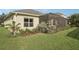 Well-maintained backyard with green lawn, lush landscaping, and screened in patio at 4020 Cottage Hill Ave, Parrish, FL 34219