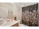 Bathroom with decorative shower curtain, wooden vanity, and a neutral color scheme at 4020 Cottage Hill Ave, Parrish, FL 34219