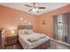 Inviting bedroom with warm-toned walls, comfortable bed, and natural light creating a peaceful retreat at 4020 Cottage Hill Ave, Parrish, FL 34219