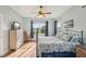 Bright bedroom with large window, ceiling fan, and cozy rocking chair offering a relaxing retreat at 4020 Cottage Hill Ave, Parrish, FL 34219