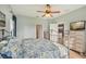 Comfortable bedroom with soft blue walls, ceiling fan, and natural light creating a serene atmosphere at 4020 Cottage Hill Ave, Parrish, FL 34219