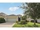 Charming single-story home featuring a two-car garage and lush landscaping at 4020 Cottage Hill Ave, Parrish, FL 34219