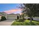 Charming home with a well-manicured lawn, mature tree and colorful landscaping at 4020 Cottage Hill Ave, Parrish, FL 34219