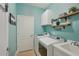 Functional laundry room with modern appliances, storage cabinets and decorative shelving at 4020 Cottage Hill Ave, Parrish, FL 34219