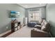 Cozy living room with comfortable seating, a large window, and modern entertainment setup at 4020 Cottage Hill Ave, Parrish, FL 34219