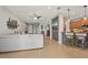 Stylish open-concept area with tile flooring, gray accent wall and views to the kitchen at 4020 Cottage Hill Ave, Parrish, FL 34219