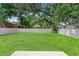 Large, level backyard with a privacy fence, perfect for outdoor activities at 406 E Selma Ave, Tampa, FL 33603