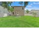 Spacious backyard with lush lawn and neutral-colored house exterior at 406 E Selma Ave, Tampa, FL 33603