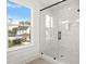Modern bathroom featuring a glass shower with white marble, hexagon tile floors and outside view at 406 E Selma Ave, Tampa, FL 33603