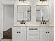 Bathroom featuring double vanities, with modern light fixtures and framed mirrors at 406 E Selma Ave, Tampa, FL 33603