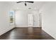 Spacious bedroom featuring hardwood floors, white walls, and a view to an adjoining bathroom at 406 E Selma Ave, Tampa, FL 33603