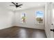 Bright bedroom with two windows, dark wood floors, and modern fixtures at 406 E Selma Ave, Tampa, FL 33603