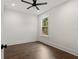 Bedroom with hardwood floors, ceiling fan and a large window offering natural light at 406 E Selma Ave, Tampa, FL 33603