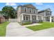 Lovely two-story home featuring a welcoming front porch, lush lawn, and long private driveway at 406 E Selma Ave, Tampa, FL 33603