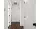 Hallway with wood floors and white walls, showcasing multiple doors and modern design elements at 406 E Selma Ave, Tampa, FL 33603