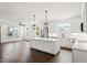 Open-concept kitchen and living space with an island, stainless steel appliances, and wood floors at 406 E Selma Ave, Tampa, FL 33603
