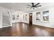 Bright and airy living area featuring hardwood floors, large windows, and staircase access at 406 E Selma Ave, Tampa, FL 33603