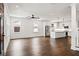 Open-concept living space with hardwood floors, white walls, and seamless flow to the kitchen at 406 E Selma Ave, Tampa, FL 33603