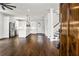 Bright open-concept living area showcasing beautiful hardwood floors and seamless access to the kitchen at 406 E Selma Ave, Tampa, FL 33603