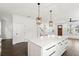 Open concept kitchen and living space featuring a kitchen island and hardwood floors at 406 E Selma Ave, Tampa, FL 33603