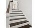 Bright staircase features modern white risers, dark wood treads, and white walls leading to the upper level at 406 E Selma Ave, Tampa, FL 33603