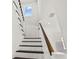 Modern staircase with wood treads, white risers, and a window at 406 E Selma Ave, Tampa, FL 33603