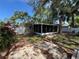 View of the rear of the home, patio and landscaped yard at 422 Crosswinds Dr, Palm Harbor, FL 34683