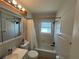 Well-lit bathroom features a shower-tub combination and classic fixtures at 422 Crosswinds Dr, Palm Harbor, FL 34683