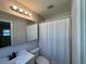 Well-lit bathroom with a large mirror and shower/tub combo at 422 Crosswinds Dr, Palm Harbor, FL 34683