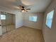 Cozy bedroom with tile floor, natural light, and mirrored closet at 422 Crosswinds Dr, Palm Harbor, FL 34683