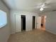 Bedroom featuring tile flooring, a ceiling fan, and closet with sliding doors at 422 Crosswinds Dr, Palm Harbor, FL 34683