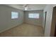 Bright bedroom features tile flooring, two windows, and ceiling fan at 422 Crosswinds Dr, Palm Harbor, FL 34683