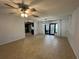 Spacious living room adjacent to the kitchen and featuring sliding glass doors to the backyard at 422 Crosswinds Dr, Palm Harbor, FL 34683