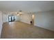 Expansive living room featuring tile flooring and sliding glass doors to the back patio at 422 Crosswinds Dr, Palm Harbor, FL 34683