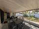 Screened-in porch area with outdoor furniture and ceiling fan at 422 Crosswinds Dr, Palm Harbor, FL 34683