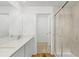 Modern bathroom featuring double sinks, quartz countertop, and a glass-enclosed shower at 4625 Vernell St, North Port, FL 34291