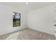 Clean, bright bedroom with neutral carpeting and a window providing natural light and outdoor views at 4625 Vernell St, North Port, FL 34291