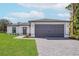 Charming single-story home featuring a gray two-car garage, gray door and meticulously maintained landscaping at 4625 Vernell St, North Port, FL 34291
