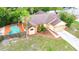 Aerial view of a lovely home with a backyard pool and lush landscaping at 4744 Burlington Rd, Land O Lakes, FL 34639